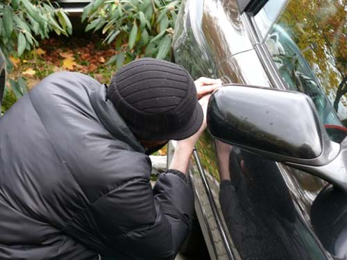 Man attempting to break into a car